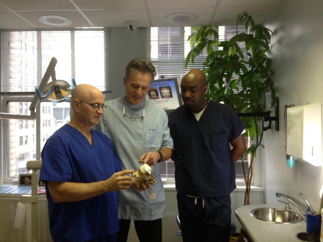 Drs. Jeff and Dan discussing a patient case with Jeffrey Jerome, Chief of Staff.